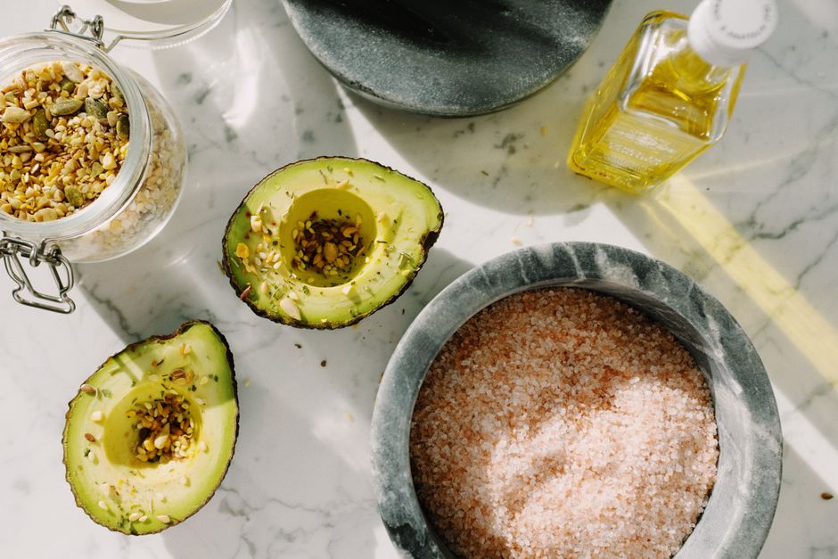 Aceite de oliva, aguacate y frutos secos sobre una mesa